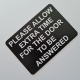 Please Allow Extra Time for the Door to be Answered Sign Plaque in Black Background with White Text