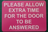 Please Allow Extra Time for the Door to be Answered Sign Plaque in Pink Background with White Text