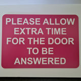Please Allow Extra Time for the Door to be Answered Sign Plaque in Pink Background with White Text