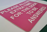 Please Allow Extra Time for the Door to be Answered Sign Plaque in Pink Background with White Text