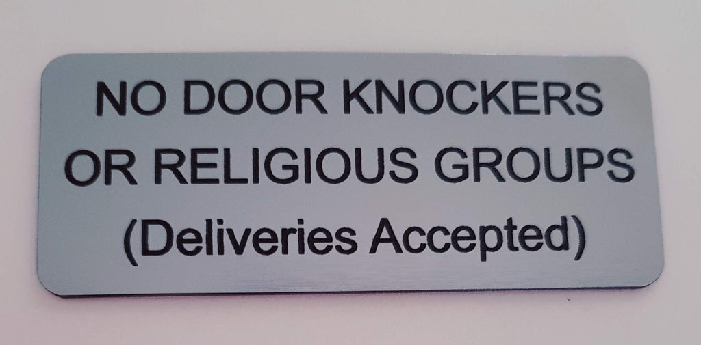 Silver sign with black text on a white background