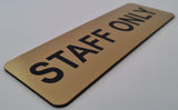 Gold sign with Black 'STAFF ONLY' text on a white background