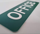 Evergreen sign with White 'OFFICE' text on a white surface