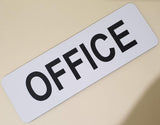 White sign with 'OFFICE' in black text on a beige background