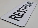 White sign with Black text 'RESTROOMS'
