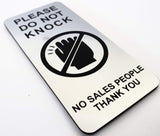 Silver sign with Black text 'Please Do Not Knock, No Sales People Thank You' on a white background