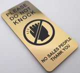 Gold sign with black text and icon on a white background