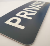 Close-up of a Navy Blue 'PRIVATE' sign with White Text