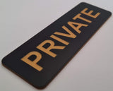 Black sign with 'PRIVATE' in gold on a white background