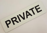 White rectangular sign with Black text 'PRIVATE'.