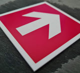 Red square acrylic sign with a white engraved directional arrow
