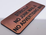 Copper acrylic sign with Black engraved text 'Strictly No Junk Mail & No Advertising' on a white background