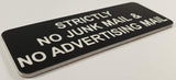 Black acrylic sign with white engraved text on a white background