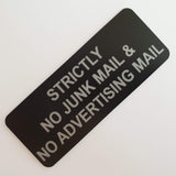 Black acrylic sign with Silver engraved text on a white background