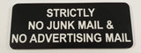 Black acrylic sign with white engraved text 'Strictly No Junk Mail & No Advertising Mail' on a light gray background