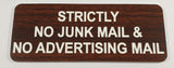 English Walnut acrylic sign with white engraved text 'Strictly No Junk Mail & No Advertising Mail' on a light gray background