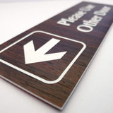 English Walnut acrylic directional sign with white engraved arrow and text on a white background