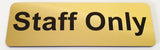 Gold sign with 'Staff Only' text in Black  on a white background