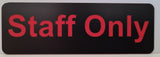 Black sign with red 'Staff Only' text on a white background