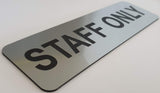 Silver sign with Black Text 'STAFF ONLY' on a white background