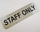 Silver sign with Black Text 'STAFF ONLY' on a white background