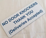 White sign with blue text on a beige background