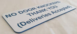 Sign on a white background with text 'NO DOOR KNOCKERS THANK YOU (Deliveries Accepted)'