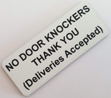 White sign with black text on a light gray background