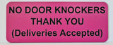 Pink sign with black text on a white background