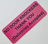 Pink sign with black text on a white background