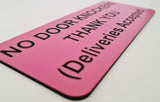 Pink sign with black text on a white surface