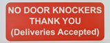 Orange sign with white text on a light gray background