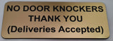 Sign on a door indicating 'No Door Knockers Thank You (Deliveries Accepted)'