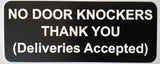 Black sign with white text on a gray background