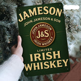 Hand holding a Jameson Irish Whiskey sign against a Christmas tree background
