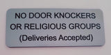 Silver sign with black text on a white background