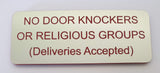 Sign with text 'NO DOOR KNOCKERS OR RELIGIOUS GROUPS (Deliveries Accepted)' on a plain background