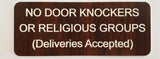 Plastic sign that looks like wood with white text on a beige background