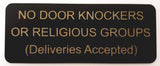 Black sign with gold text on a white background