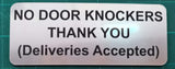 Metal sign on a green cutting mat with text 'NO DOOR KNOCKERS THANK YOU (Deliveries Accepted)'