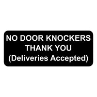 Black sign with white text 'NO DOOR KNOCKERS THANK YOU (Deliveries Accepted)' on a white background