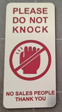 Silver Sign with Red Text 'Please do not knock, no sales people thank you'.