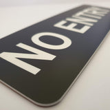 Close-up of a Black 'NO ENTRY' sign with white text