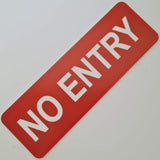 Orange 'NO ENTRY' sign white white text