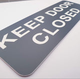 Smoke Grey acrylic sign with white text 'KEEP DOOR CLOSED'
