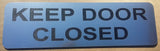 Silver acrylic sign with Black text 'KEEP DOOR CLOSED'