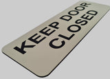 Almond acrylic sign with Black text 'KEEP DOOR CLOSED'