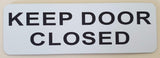 Rectangular White acrylic sign with Black text 'KEEP DOOR CLOSED'