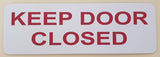 Rectangular white acrylic sign with Red text 'KEEP DOOR CLOSED'