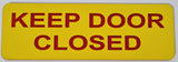 Yellow acrylic sign with red text 'KEEP DOOR CLOSED'